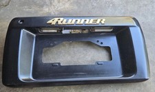 1996-2002 TOYOTA 4RUNNER REAR HATCH LICENSE PLATE HOLDER PANEL GOLD EMBLEM OEM. picture