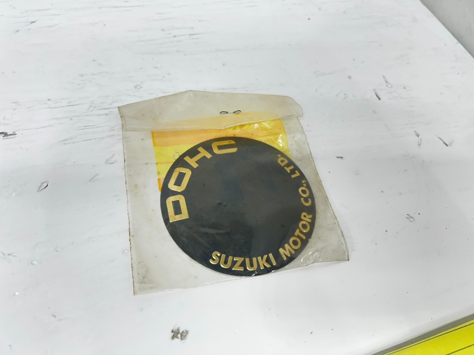 1977-1980 Suzuki GS 550 New Old Stock Ignition Emblem Cover 68235-47100 1977-1980 Suzuki GS 550 New Old Stock Ignition Emblem Cover 68235-47100