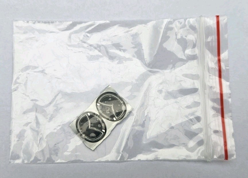 Two (2) Oval Shaped Mazda 2 3 Logo Sticker For Key Fob. Two (2) Oval Shaped Mazda 2 3 Logo Sticker For Key Fob.