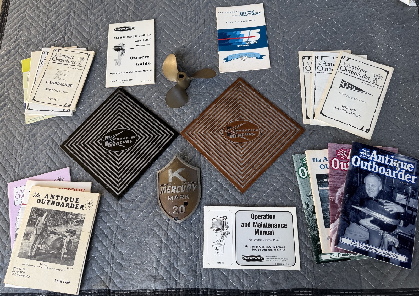 vintage Kiekhaefer Mercury outboard floor tiles + prop, shield & misc literature vintage Kiekhaefer Mercury outboard floor tiles + prop, shield & misc literature