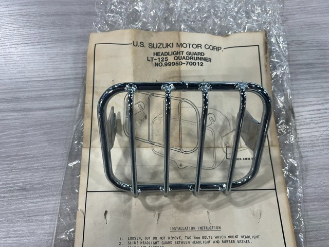 Suzuki 99950-70012, Headlight Guard, Vintage 1983 - 1987 LT-125 QuadRunner