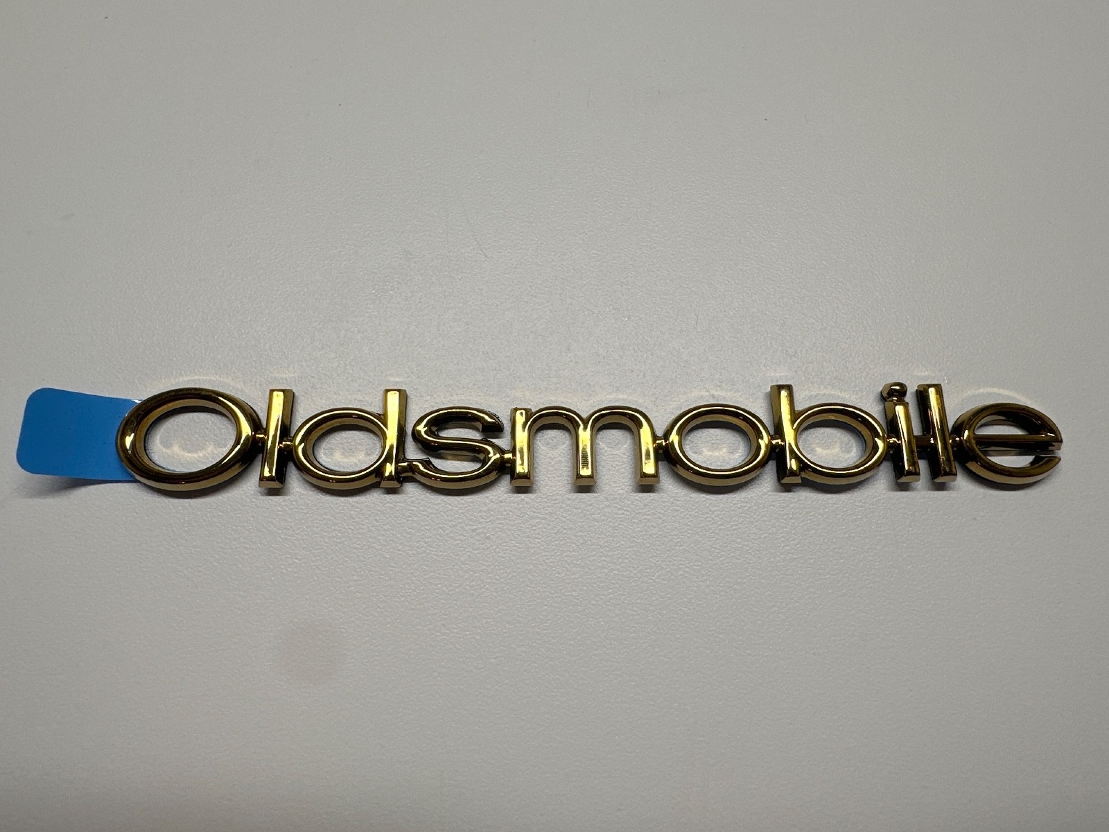 Genuine GM Oldsmobile gold Nameplate 10342809 Genuine GM Oldsmobile gold Nameplate 10342809