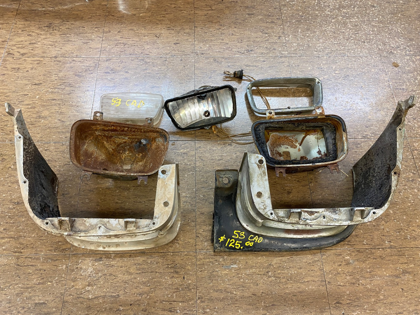 Pair of 53 Cadillac Radiator Extension Moldings Fog Lamp Housings and Bezel